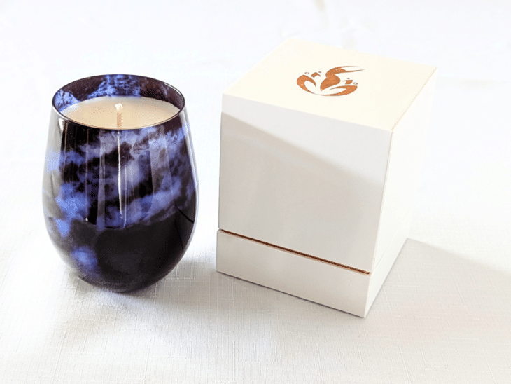 BathCalm's Midnight Magic Candle is set in a stunning indigo blue jar, evocative of a cloudy night sky.