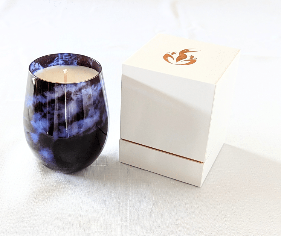 BathCalm's Midnight Magic Candle is set in a stunning indigo blue jar, evocative of a cloudy night sky.