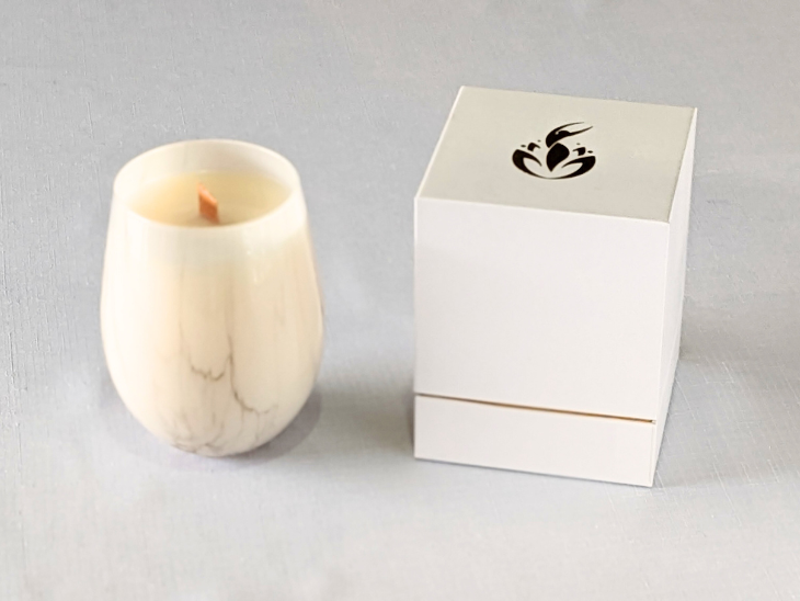 BathCalm's Ambrosian Romance Candle is set in a stylish white jar, with a marble-look finish. BathCalm’s wooden wick candle is made from environmentally friendly Ecococowax. Each candle has a burn time of 60+ hours and comes with its own luxury white and gold branded box.